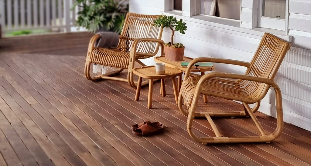 Two outdoor lounge chairs and the veranda with teak coffee tables 