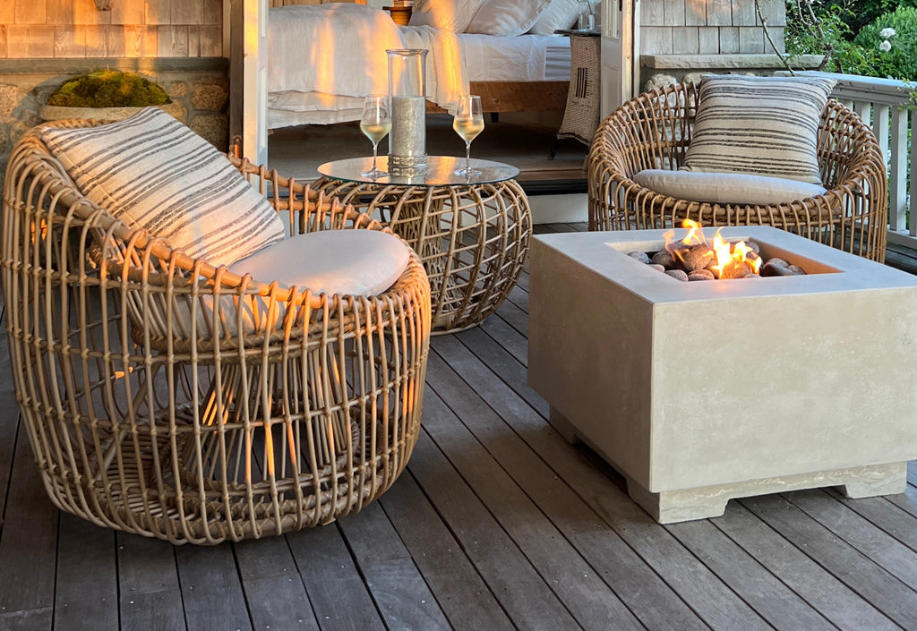 Two lounge chairs at sunset on the veranda with a round coffee table