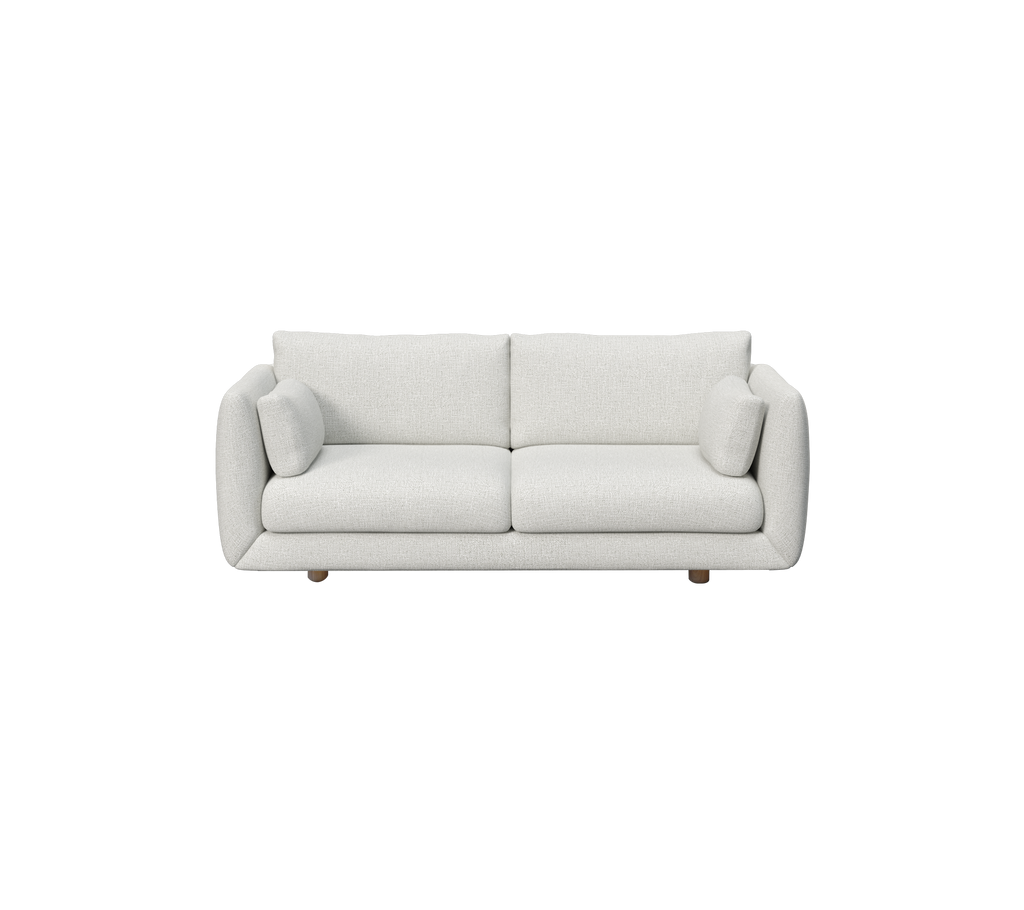 Hellgraues Sofa mit runden Kissen im modernen, minimalistischen Stil.