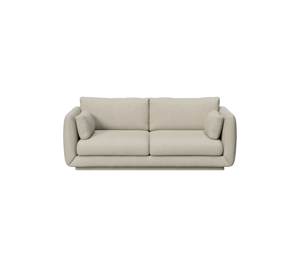 Hellebraune Couch mit runden Kissen in modernem Design.