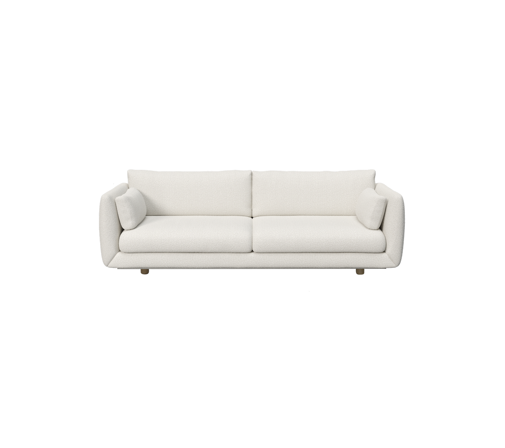 Moderne weiße Sofa mit zylindrischen Kissen.