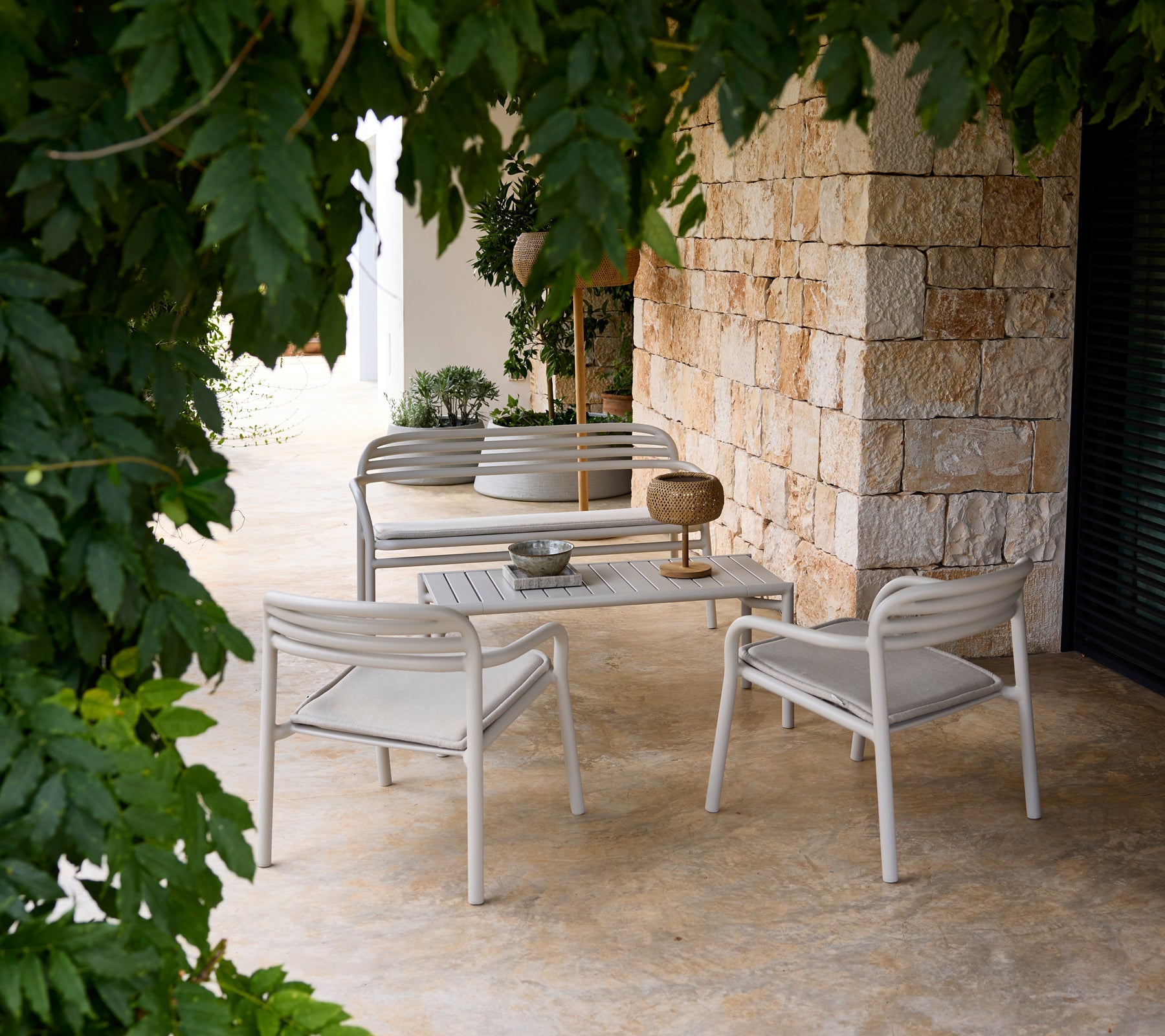 Grau Sofa und Stuhl mit einem weißen Tisch in einem modernen Lounge-Setting.